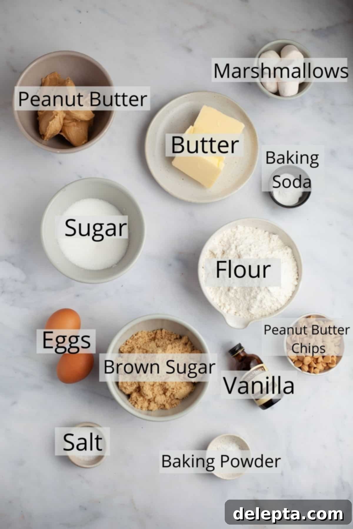 Peanut Butter Mallow Bliss Cookies 3 All the pre-measured ingredients for peanut butter marshmallow cookies neatly arranged in small bowls on a wooden surface, ready for the baking process.