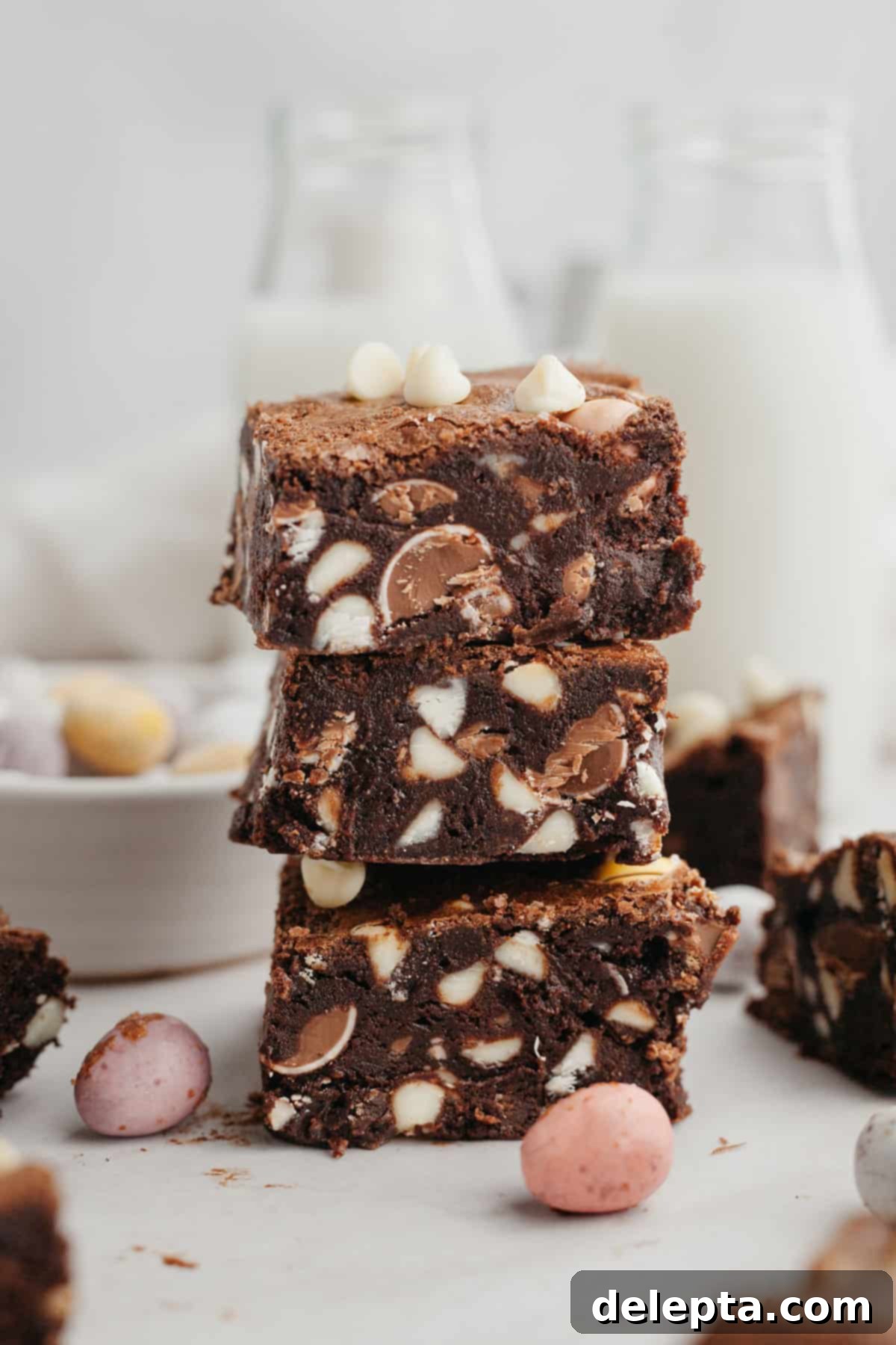 Rainbow Speckled Fudgy Mini Egg Brownies 2 A stack of three intensely fudgy mini egg brownies, topped with colorful Cadbury mini eggs, ready to be enjoyed for Easter.