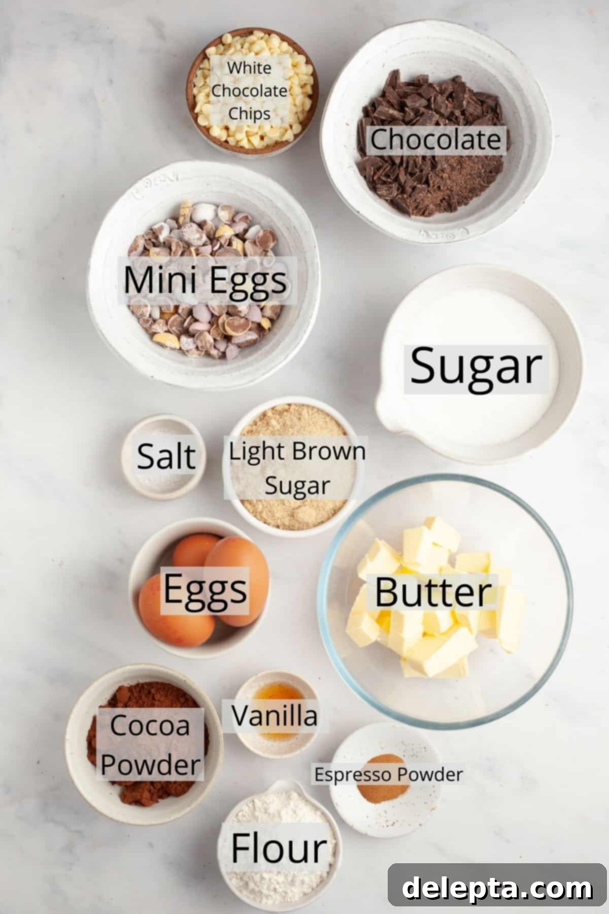 Rainbow Speckled Fudgy Mini Egg Brownies 3 All the essential ingredients for making fudgy mini egg brownies, precisely weighed and displayed in small bowls.