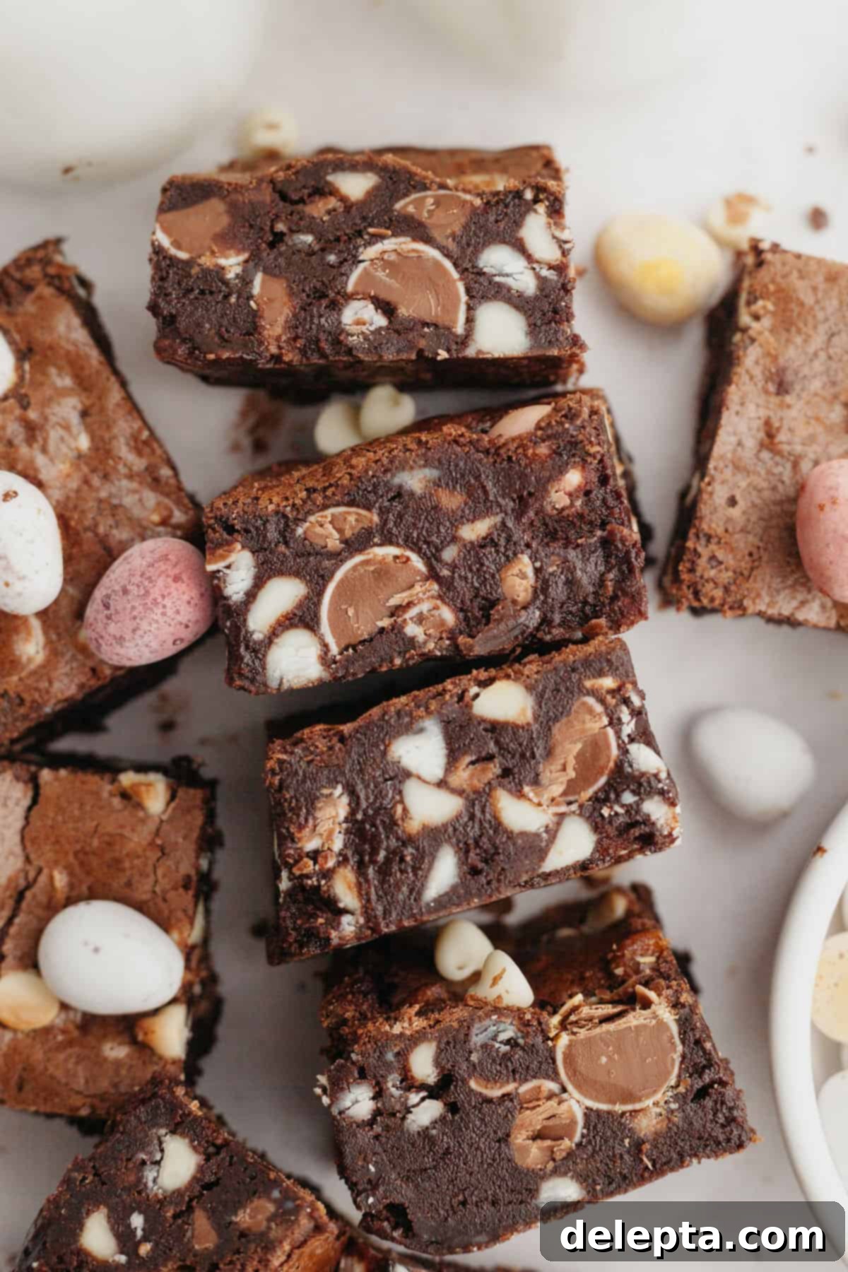 Rainbow Speckled Fudgy Mini Egg Brownies 9 A close-up shot of a perfect mini egg brownie, showcasing its rich texture and colorful candy pieces.