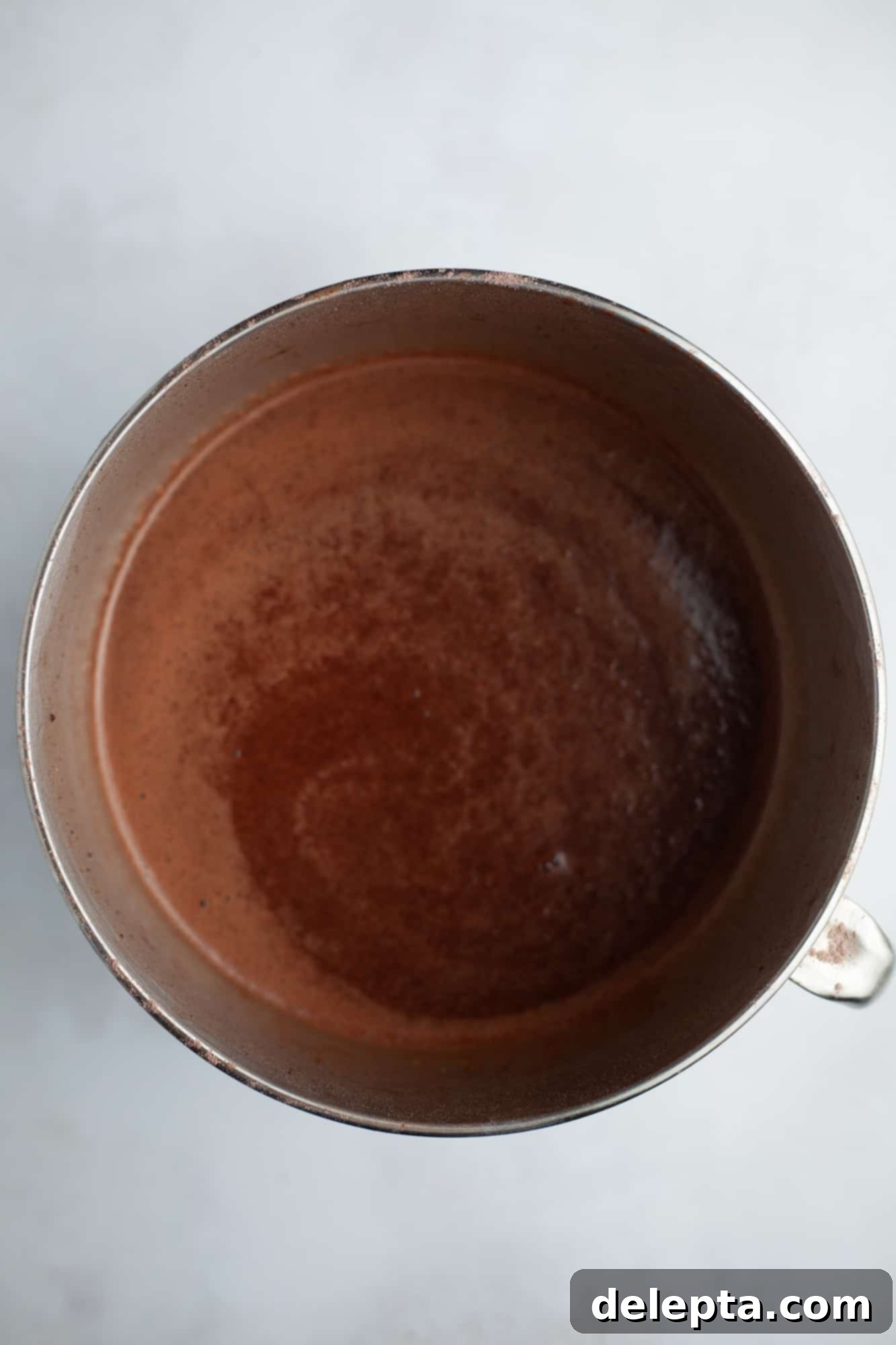 Peanut Butter Chocolate Nirvana 8 A large silver mixing bowl with chocolate cake batter in it
