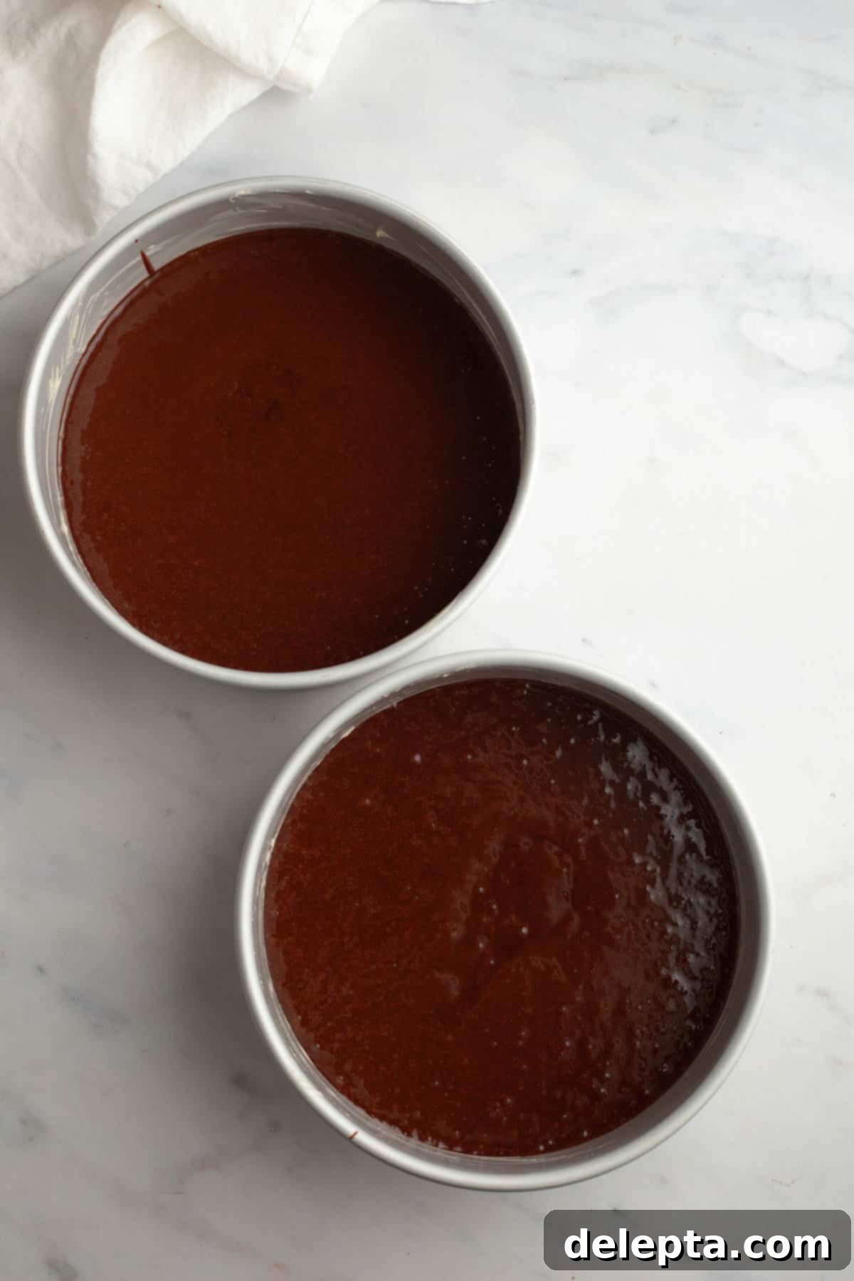 Matilda's 20 Minute Chocolate Cake 7 Unbaked chocolate cakes in cake pans.