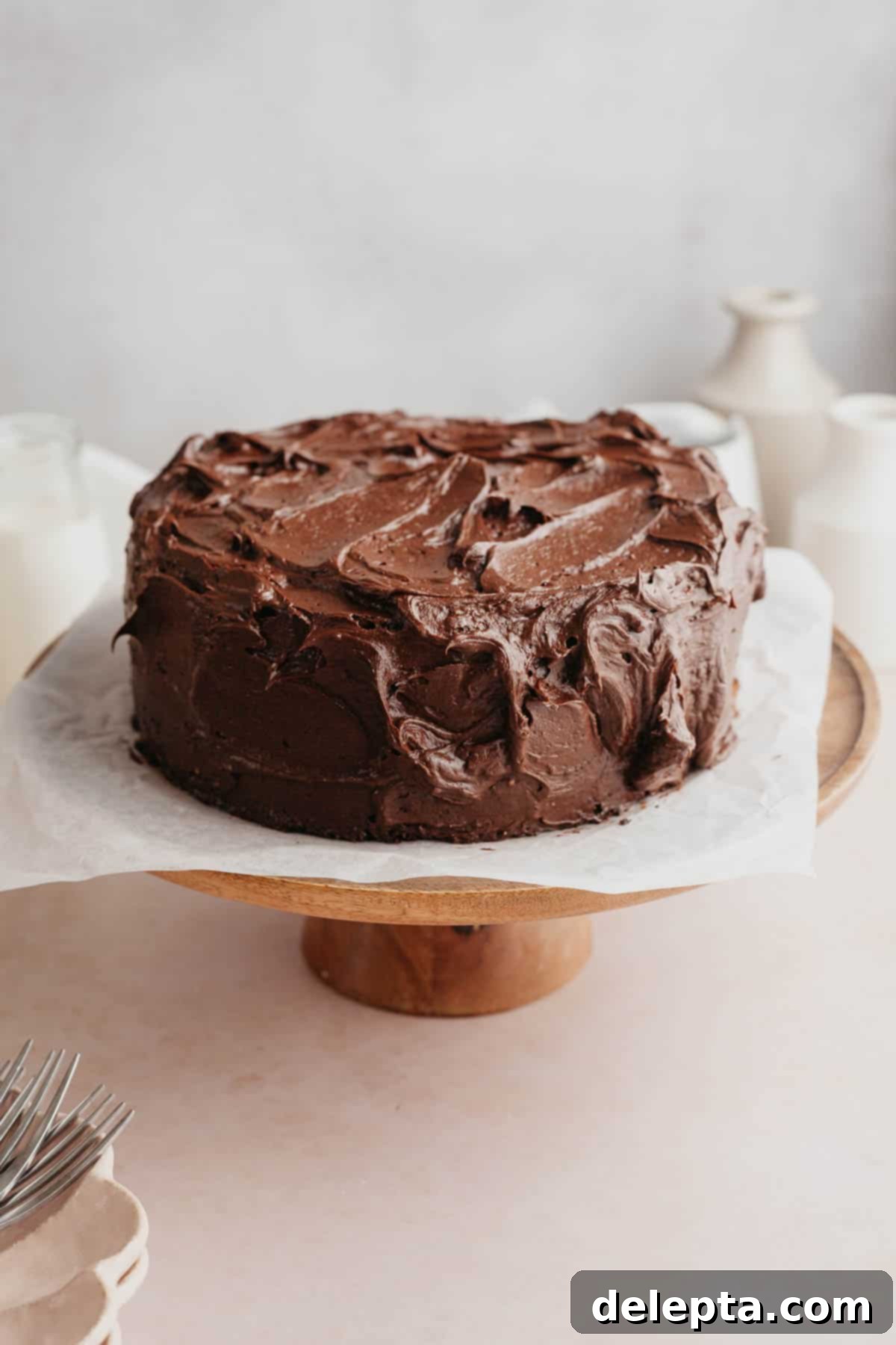 Matilda's 20 Minute Chocolate Cake 10 A chocolate frosted cake on a cake stand.
