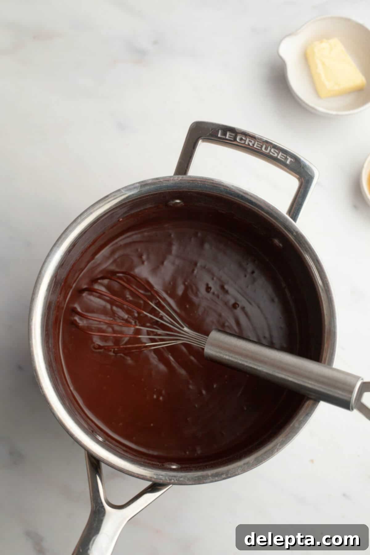 Spooky Simple Homemade Chocolate Pudding Dirt Cups 6 Chocolate pudding in a saucepan with a whisk.