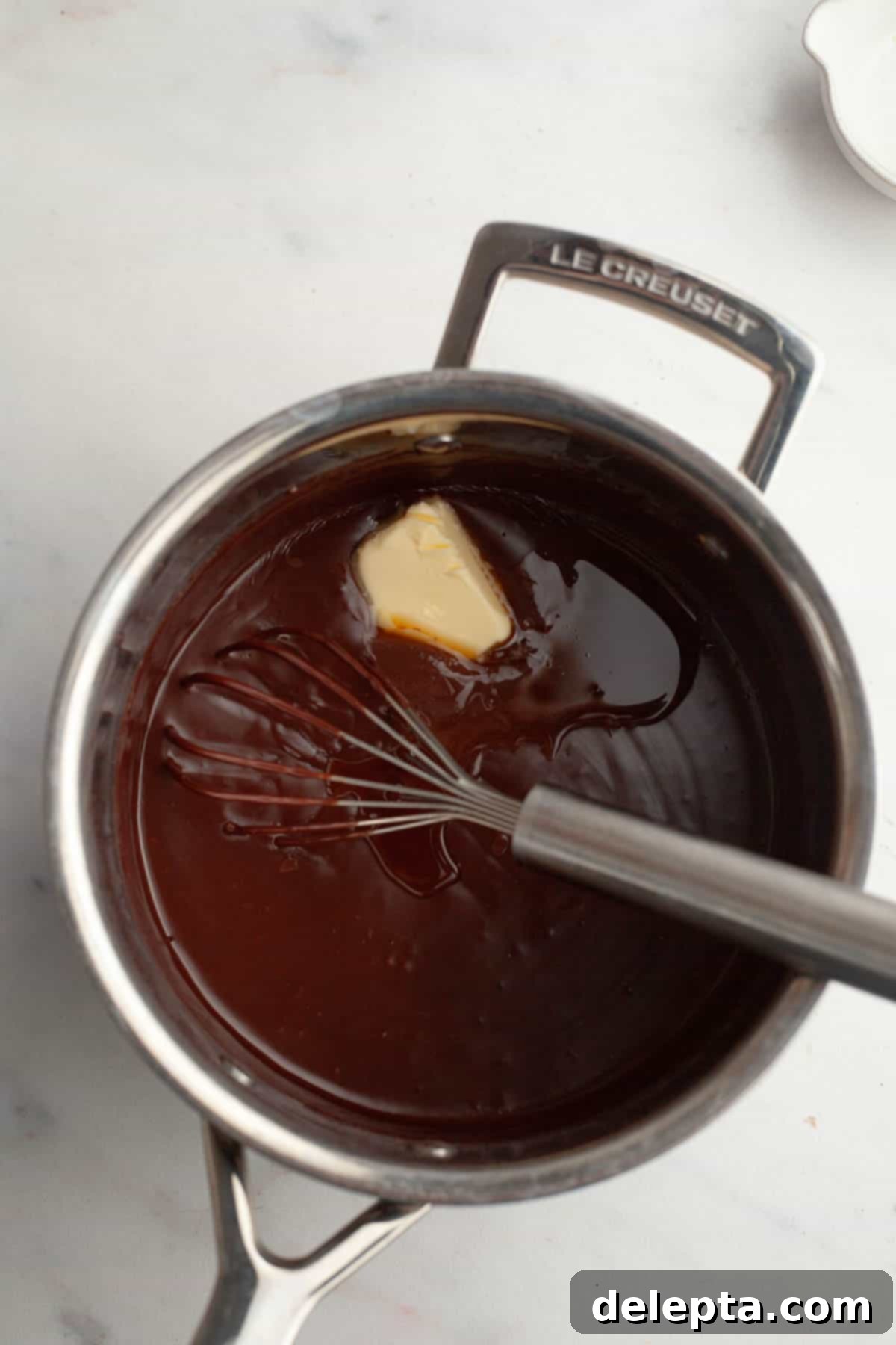 Spooky Simple Homemade Chocolate Pudding Dirt Cups 7 Chocolate pudding with a pat of butter in a saucepan.