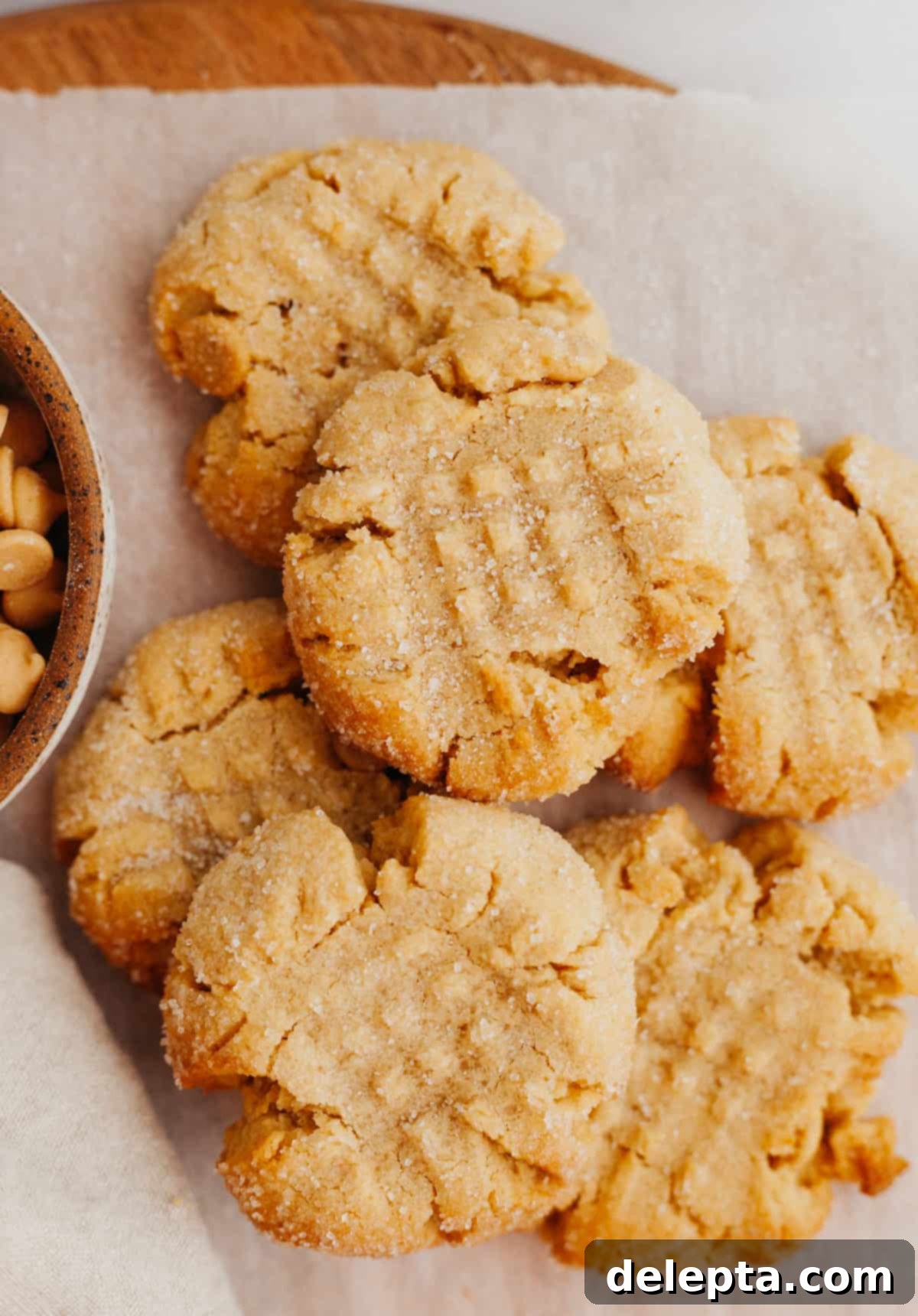 Peanut Butter Bliss in a Small Batch 6 A small, inviting pile of six freshly baked peanut butter cookies arranged neatly on parchment paper.