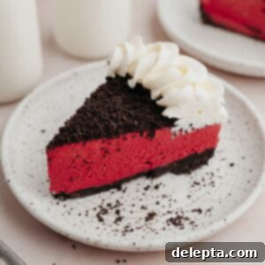 Decadent No-Bake Red Velvet Oreo Cheesecake 9 A slice of red velvet oreo cheesecake on a small white plate.