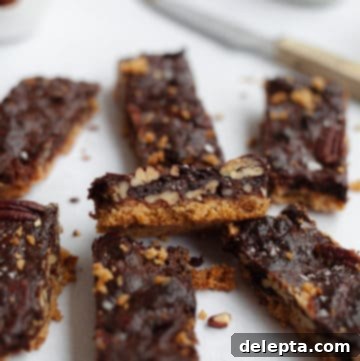 Decadent Chocolate Pecan Pie Bars 6 7 pecan pie bars on some parchment paper