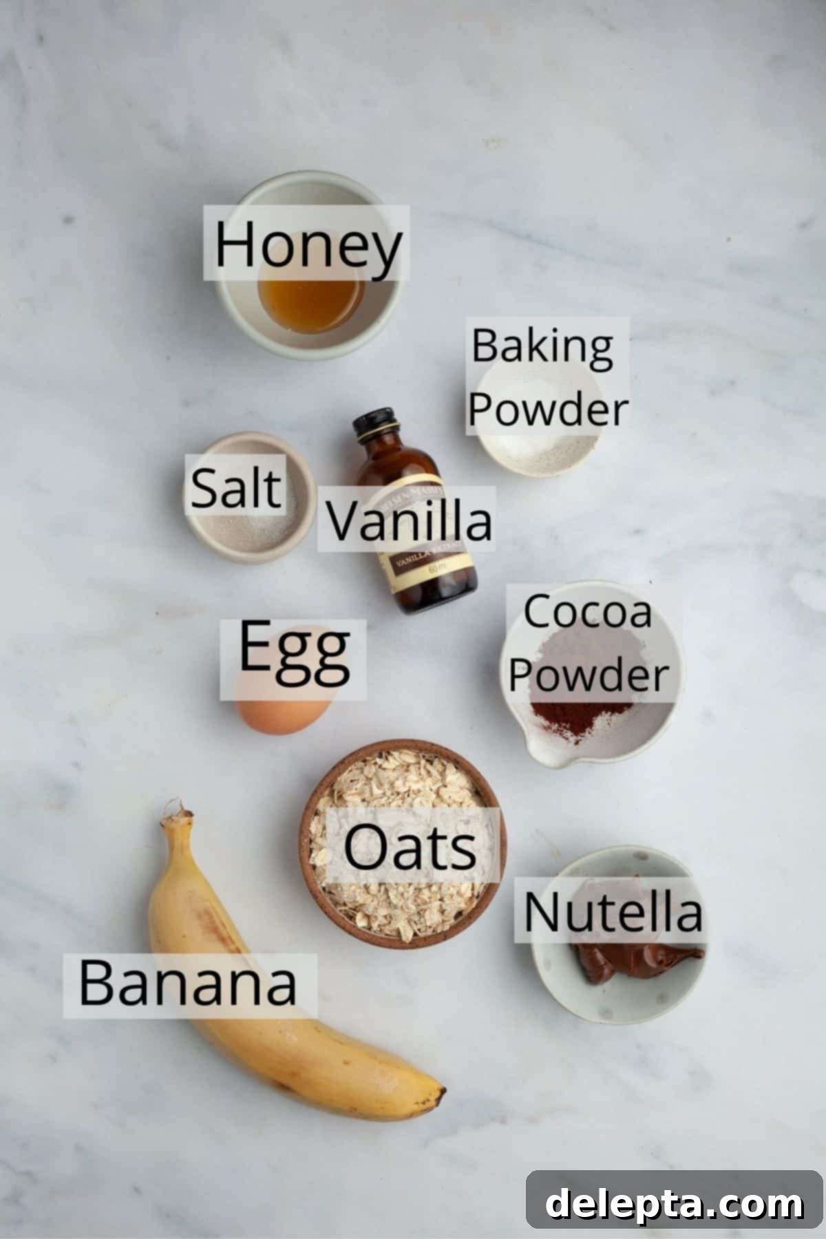 Decadent Nutella Baked Oats 3 All the essential ingredients for Nutella baked oats, meticulously weighed and displayed in small, neat bowls, showcasing their freshness and readiness for preparation.