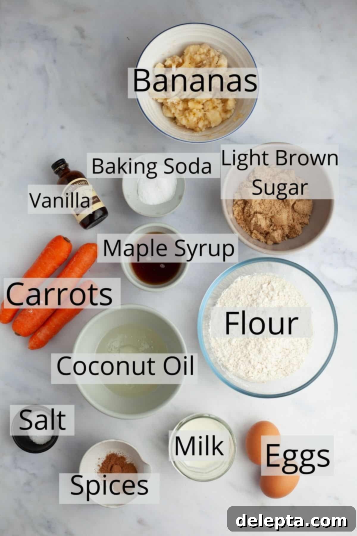 Sunshine Carrot Banana Muffins 3 All the ingredients for banana carrot muffins weighed out into small bowls, including flour, eggs, shredded carrots, mashed bananas, and spices.