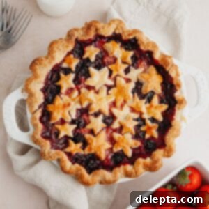 Double Berry Bliss Pie 12 A mixed berry pie covered in star pastry cutouts, ready for serving.