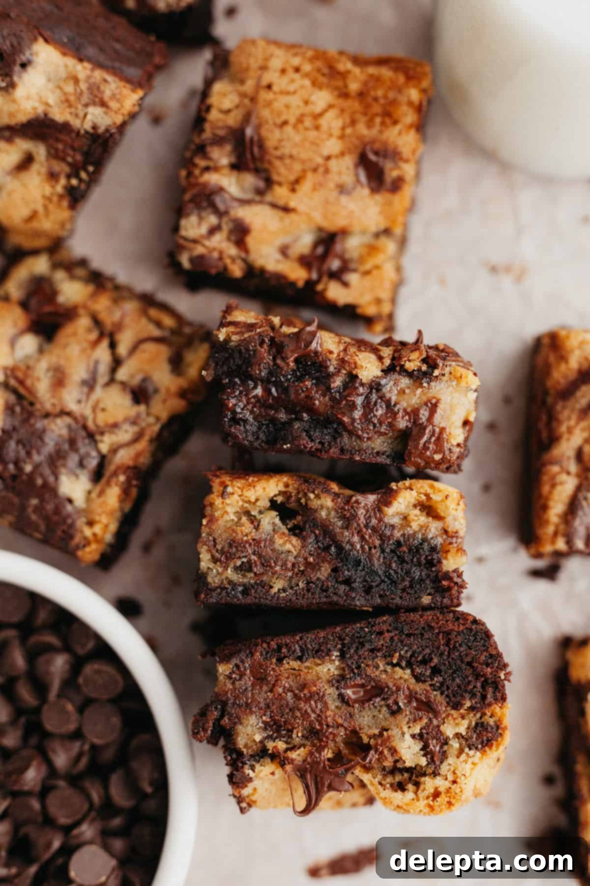 Ultimate Oreo Brookies 11 A close up of Oreo brookies on parchment paper, showing the delightful texture and Oreo chunks.