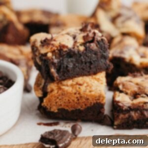 Ultimate Oreo Brookies 12 A close up of two Oreo brookies stacked on top of each other, showcasing their distinct layers and delicious texture.