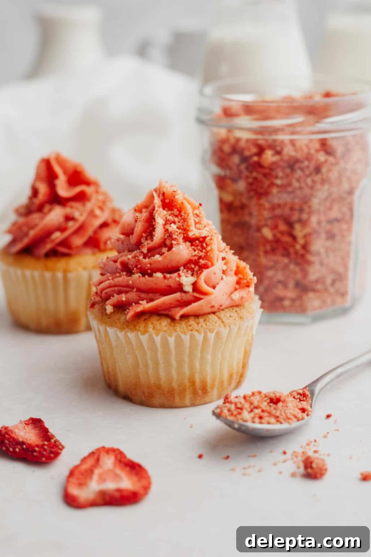 Effortless Strawberry Shortcake Crumble 5 A cupcake with pink frosting covered in a pink crumble topping, showcasing its decorative appeal.