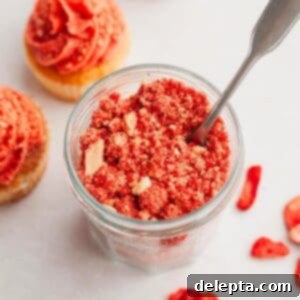 Effortless Strawberry Shortcake Crumble 6 Strawberry shortcake crumble topping in a jar with a spoon.