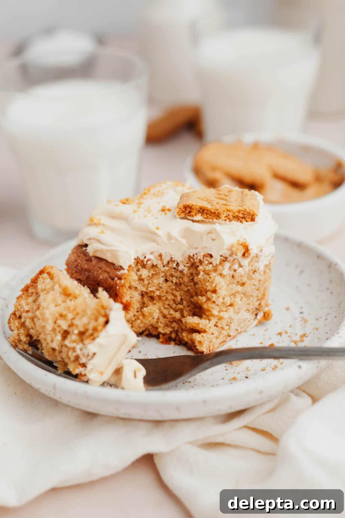 Effortless Lotus Biscoff Cake 9 A slice of Biscoff cookie butter cake on a small plate.