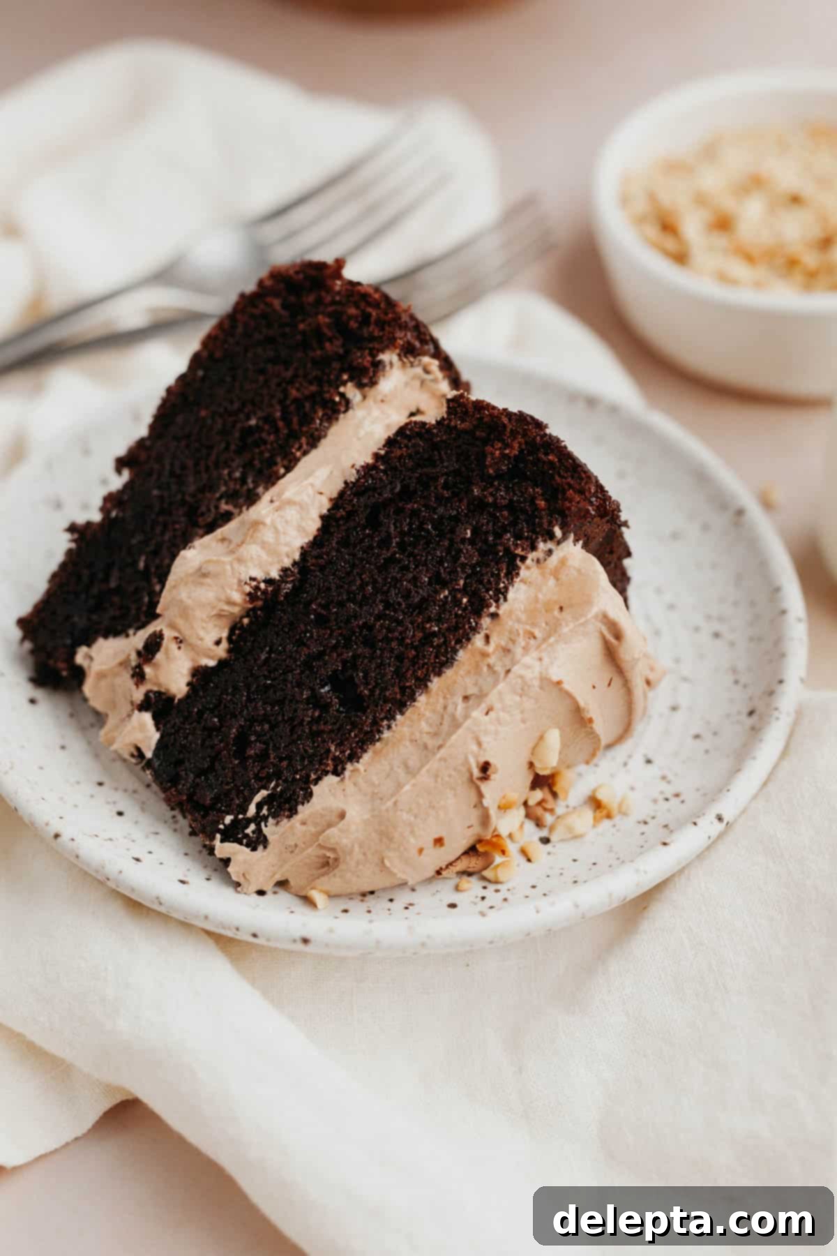 Decadent Nutella Delight 2 A beautifully sliced Nutella chocolate cake, showcasing its moist layers and creamy frosting, elegantly presented on a small plate.
