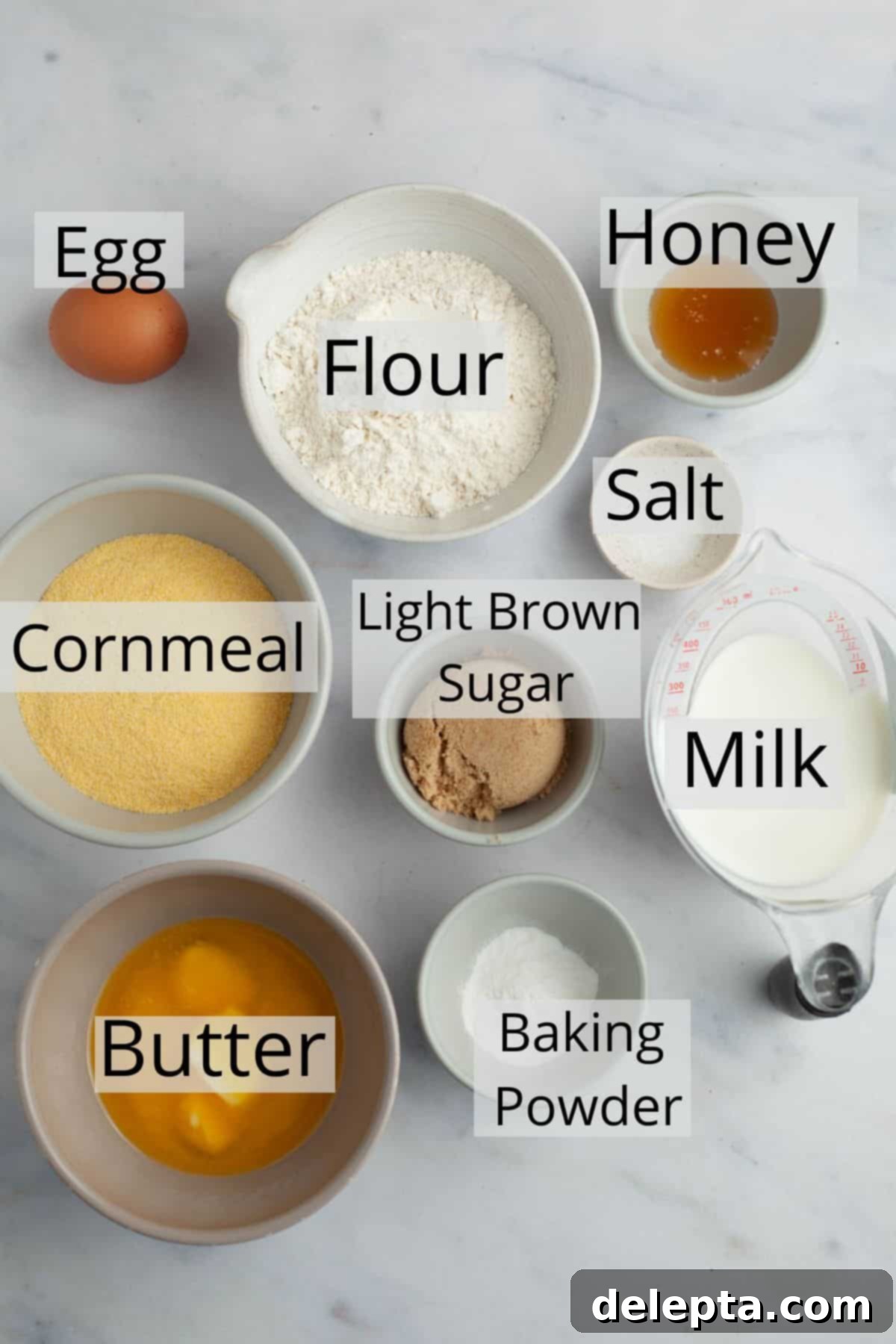 Pantry Staple Cornbread 3 Ingredients for buttermilk-free cornbread laid out, including cornmeal, flour, butter, milk, and honey