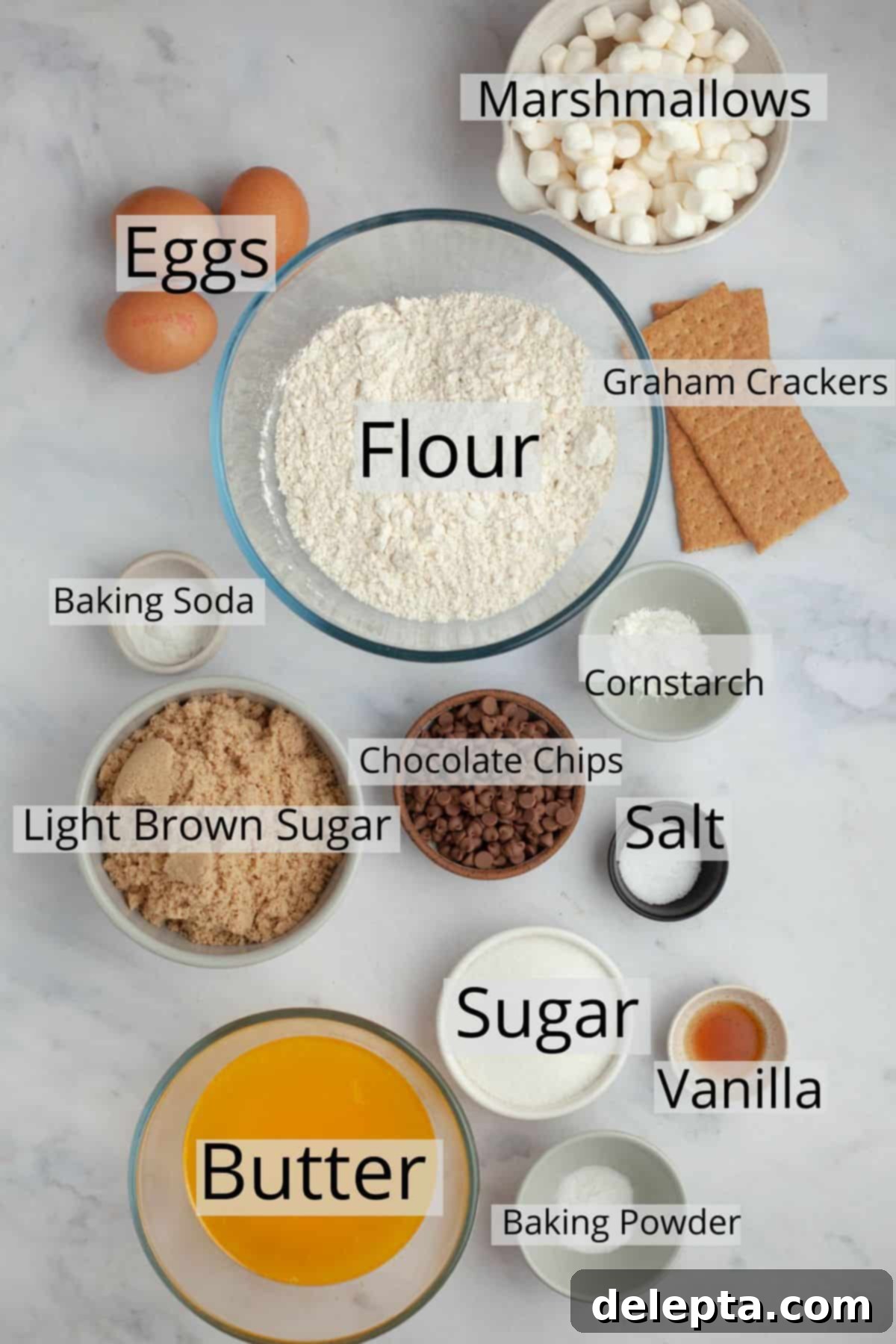 Campfire Skillet Chocolate Chip S'mores 3 All the ingredients neatly laid out for a s'mores chocolate chip cookie skillet recipe: butter, sugars, eggs, vanilla, flour, leavening agents, cornstarch, marshmallows, chocolate chips, and graham crackers.