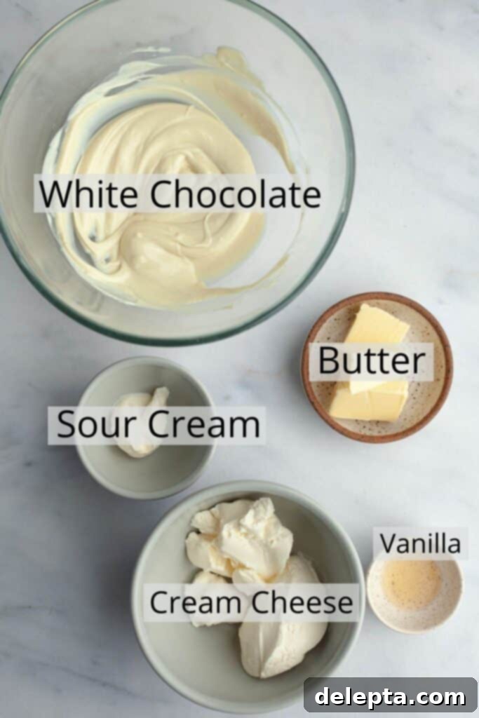 Lemon-Kissed Cranberry Loaf with White Chocolate Embrace 4 Ingredients for the luscious white chocolate cream cheese frosting, precisely measured and displayed in small bowls, featuring cream cheese, unsalted butter, sour cream, melted white chocolate, and vanilla extract.