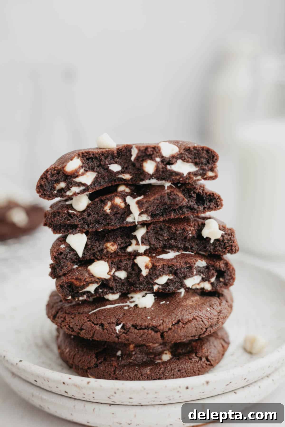 Chocolate Chip Showcase Cookies 2 A stack of inside out chocolate chip cookies broken in half, showing the fudgy inside.