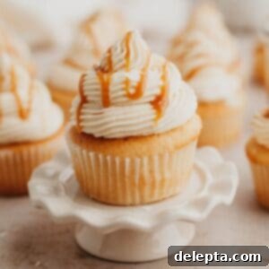 Caramel Burst Cupcakes 14 Caramel filled cupcakes, the one at the front is on a small cupcake stand.