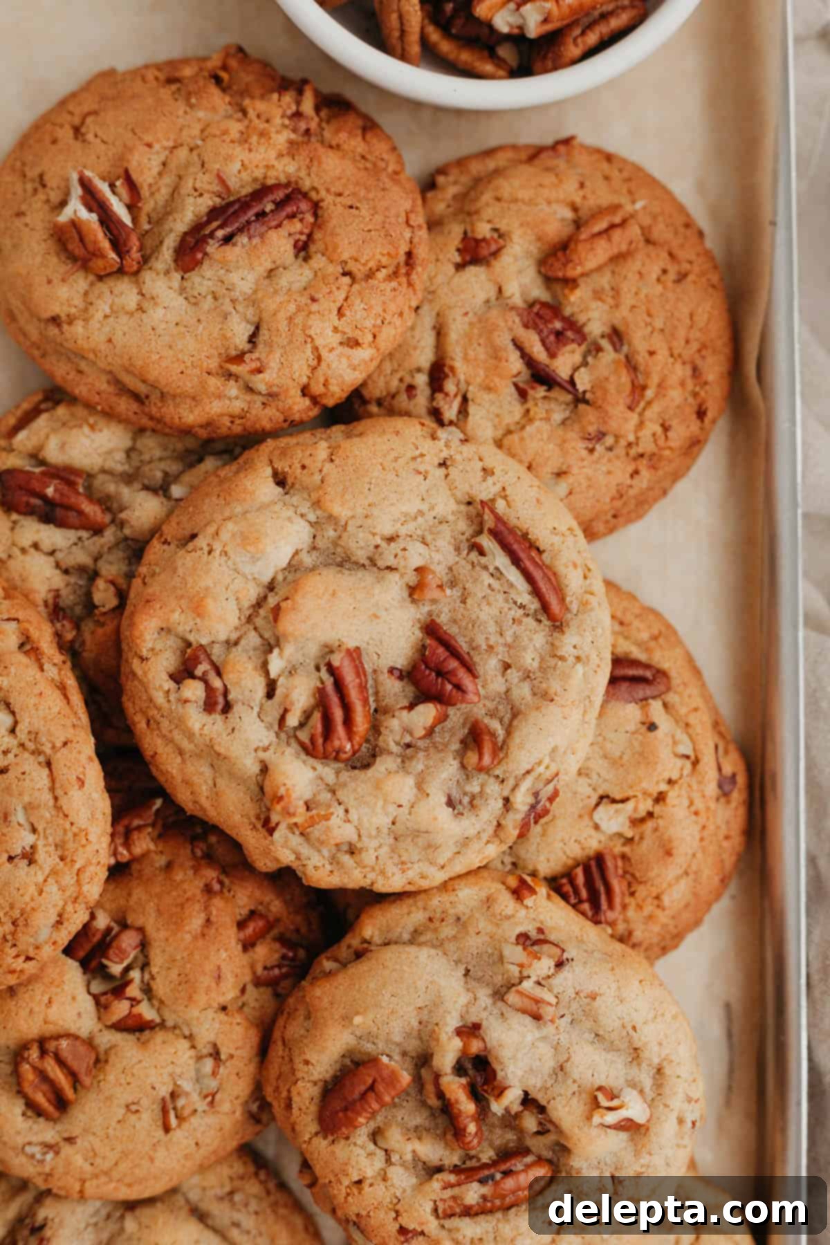 Toasted Butter Pecan Gems 2 A perfectly arranged pile of golden browned butter pecan cookies, ready to be enjoyed.