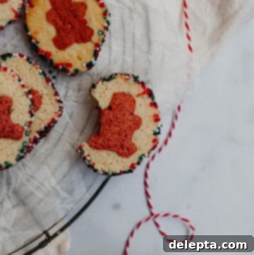 Effortless Holiday Cookie Bliss 6 pile of slice and bake cookies on parchment paper, one with a bite taken out