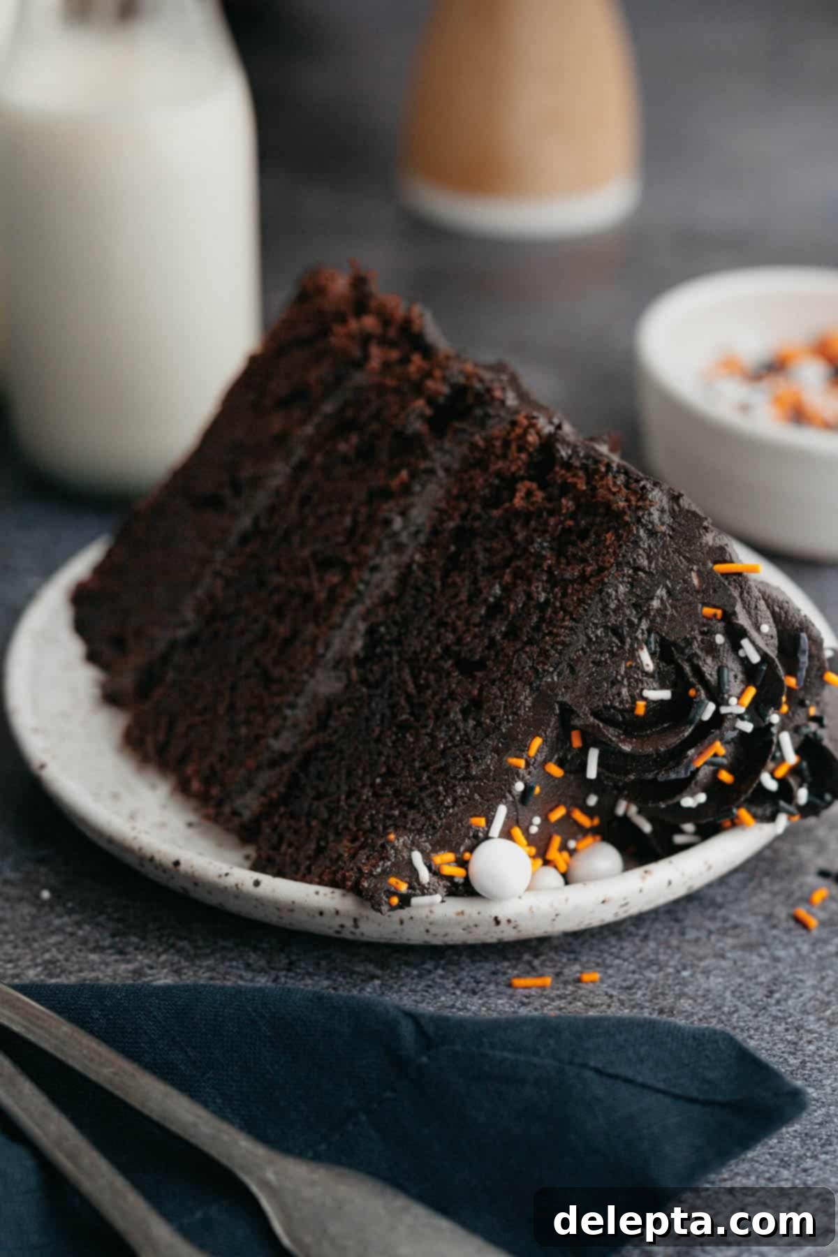 Midnight Velvet Indulgence 9 A slice of black velvet cake on a small plate.