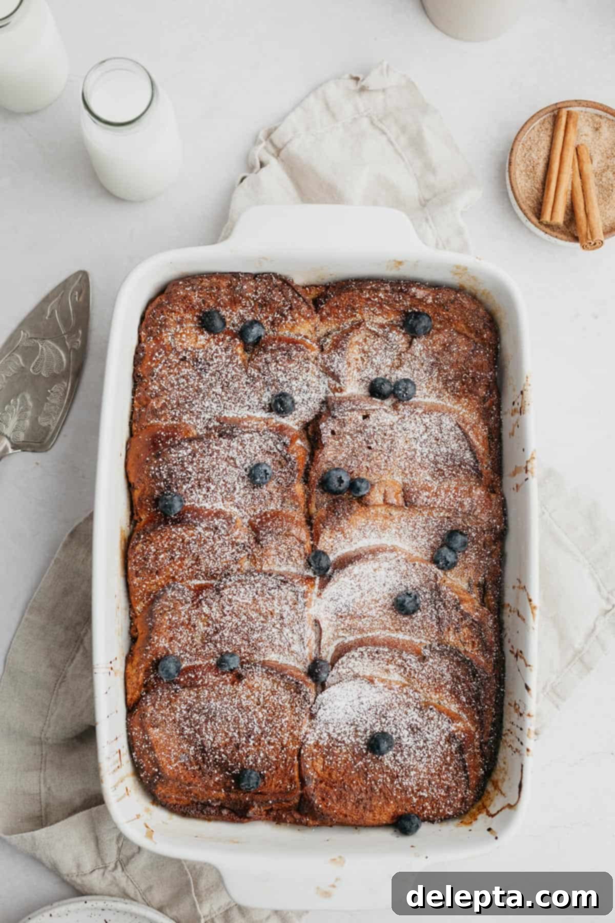 Decadent Brioche French Toast Bake 2 Baked french toast topped with blueberries and maple syrup.