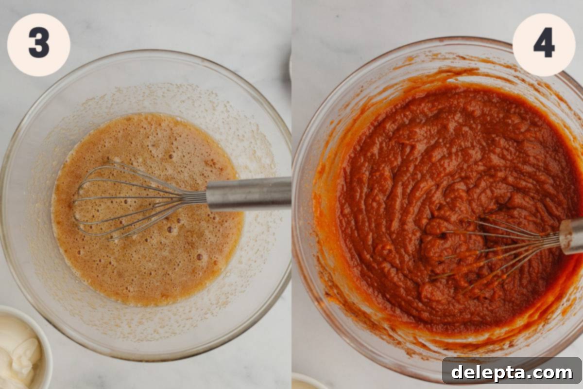 Creamy Pumpkin Dream Pie 5 A large mixing bowl containing a smooth, creamy pumpkin pie filling mixture, with a whisk resting inside.