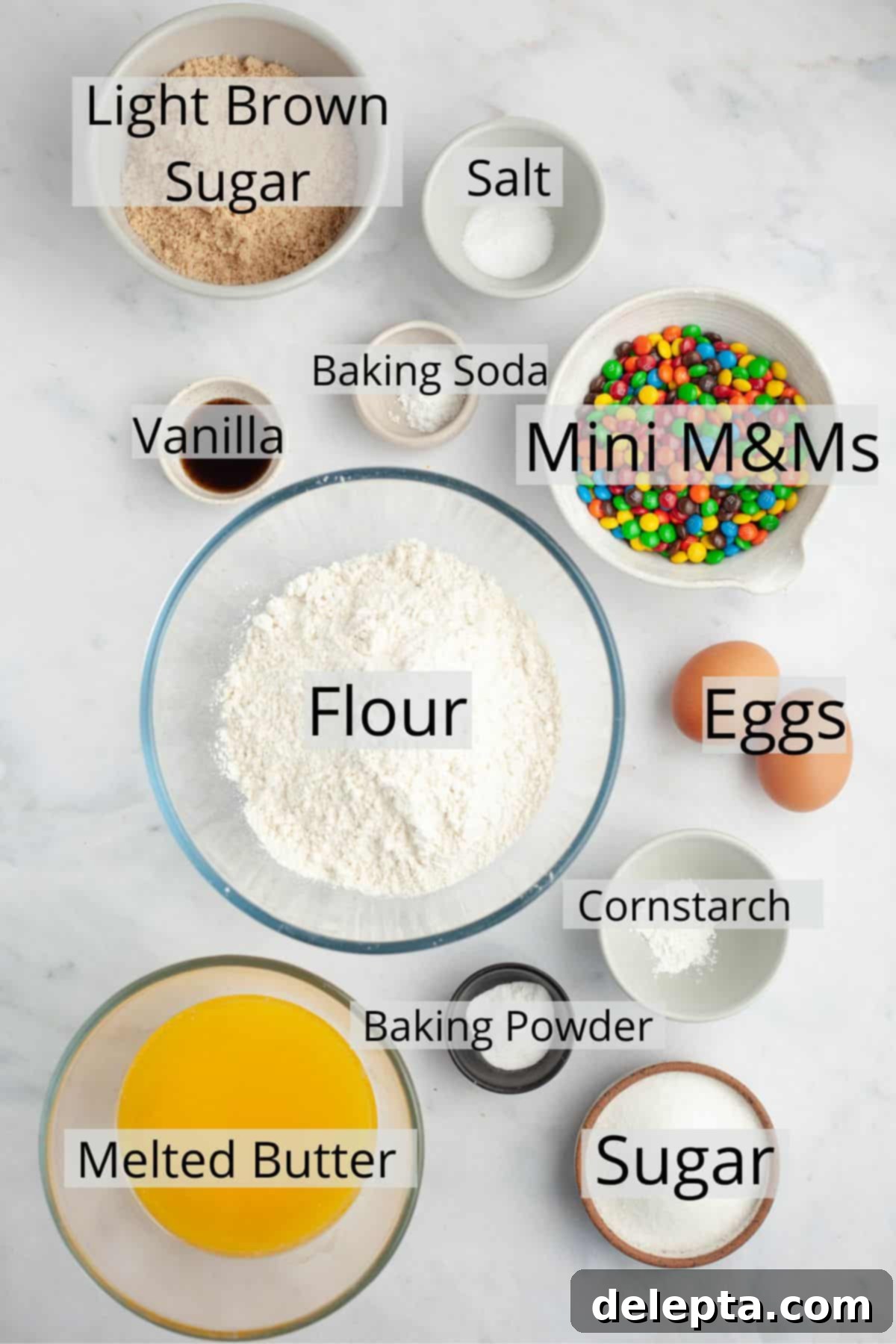 Pillowy M&M Cookie Bites 3 All the pre-measured ingredients for mini M&M cookies arranged in small bowls, ready for baking.
