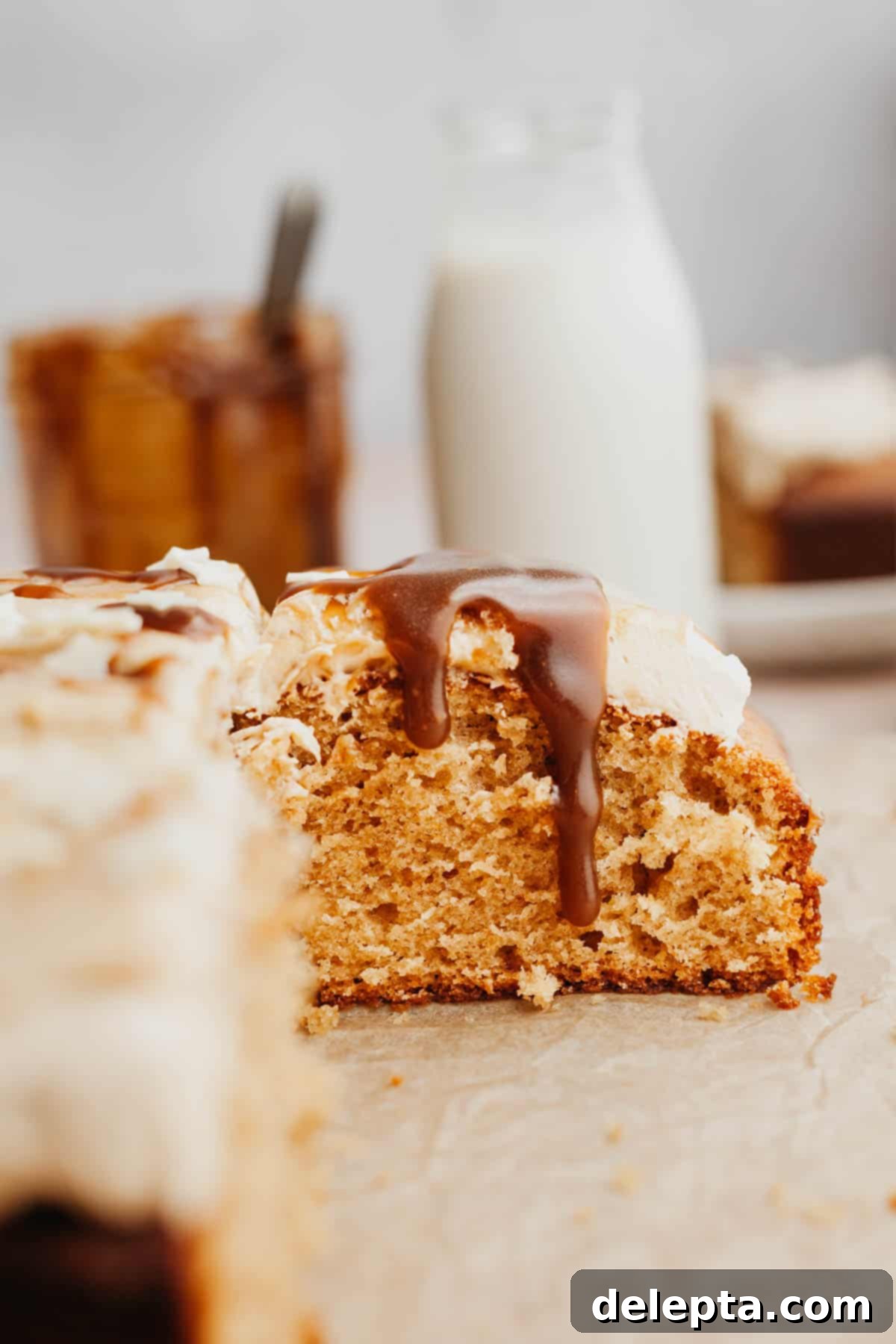 Golden Butterscotch Dream 2 A generous slice of moist butterscotch cake, artfully drizzled with warm, golden butterscotch sauce, highlighting its rich texture and inviting aroma.