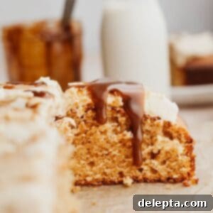 Golden Butterscotch Dream 10 A slice of moist butterscotch cake featuring a luscious homemade butterscotch sauce cascading down its side, ready to be enjoyed.