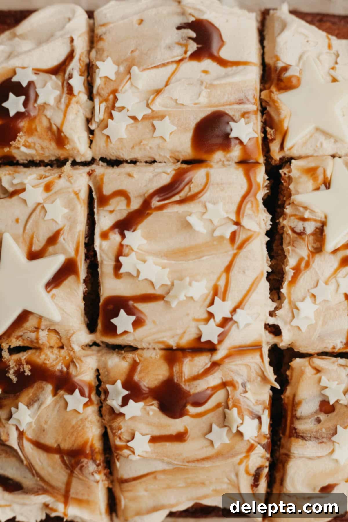 Golden Butterscotch Dream 8 An inviting overhead shot of a perfectly square butterscotch cake, generously frosted and adorned with delicate white chocolate stars, ready to be enjoyed.