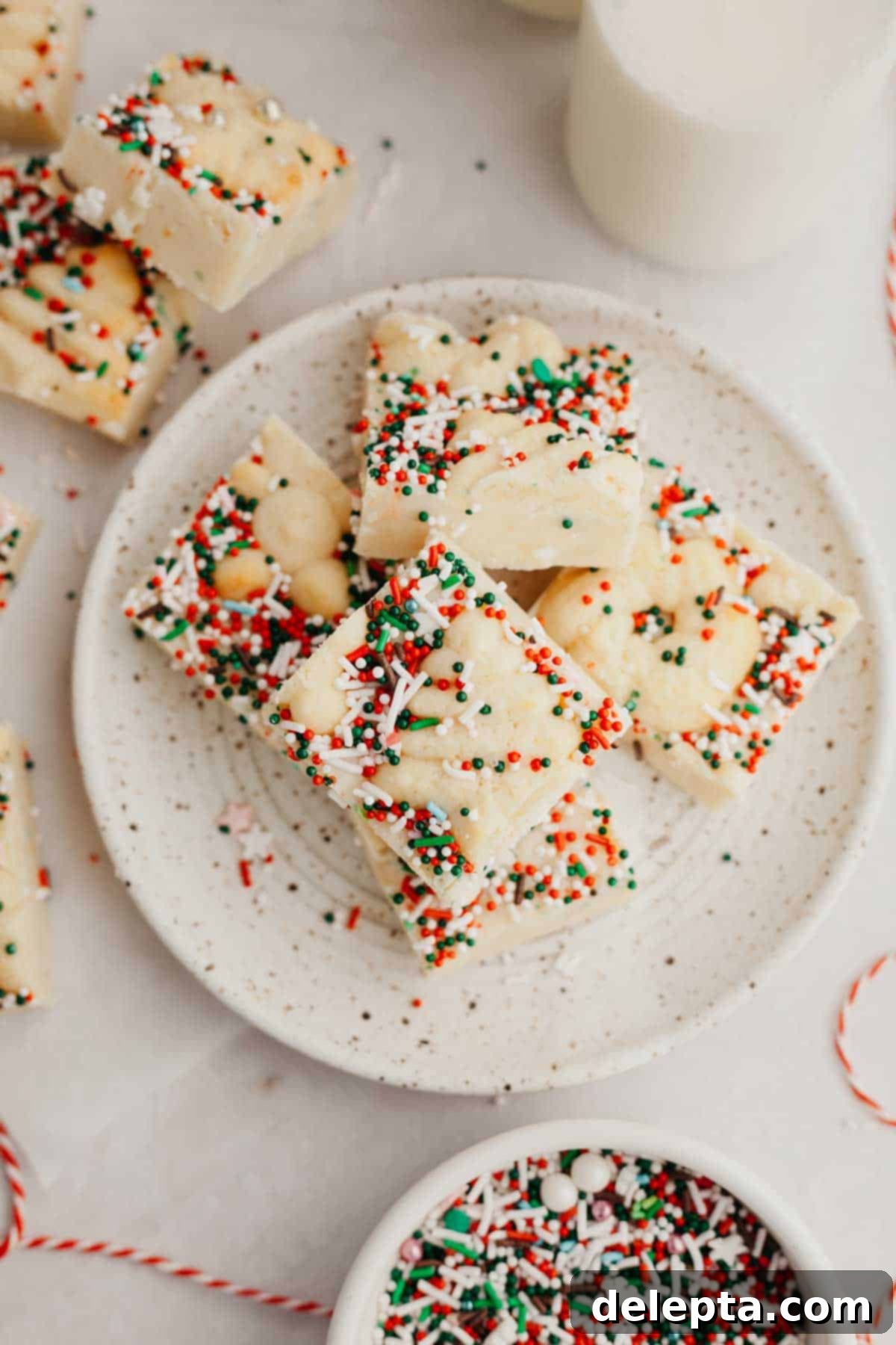 Festive Christmas Cookie Fudge 6 A small plate with Christmas cookie fudge pieces on it, ready to be enjoyed as a festive treat.