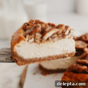Decadent Pecan Pie Cheesecake 10 A whole Pecan Pie Cheesecake, exquisitely topped with a rich caramel pecan sauce, ready to be served.