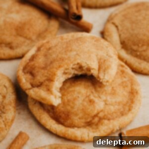 Nutty Brown Butter Snickerdoodles 9 A close up of soft and chewy browned butter snickerdoodles, one cookie has a bite taken out of it, revealing its tender interior.