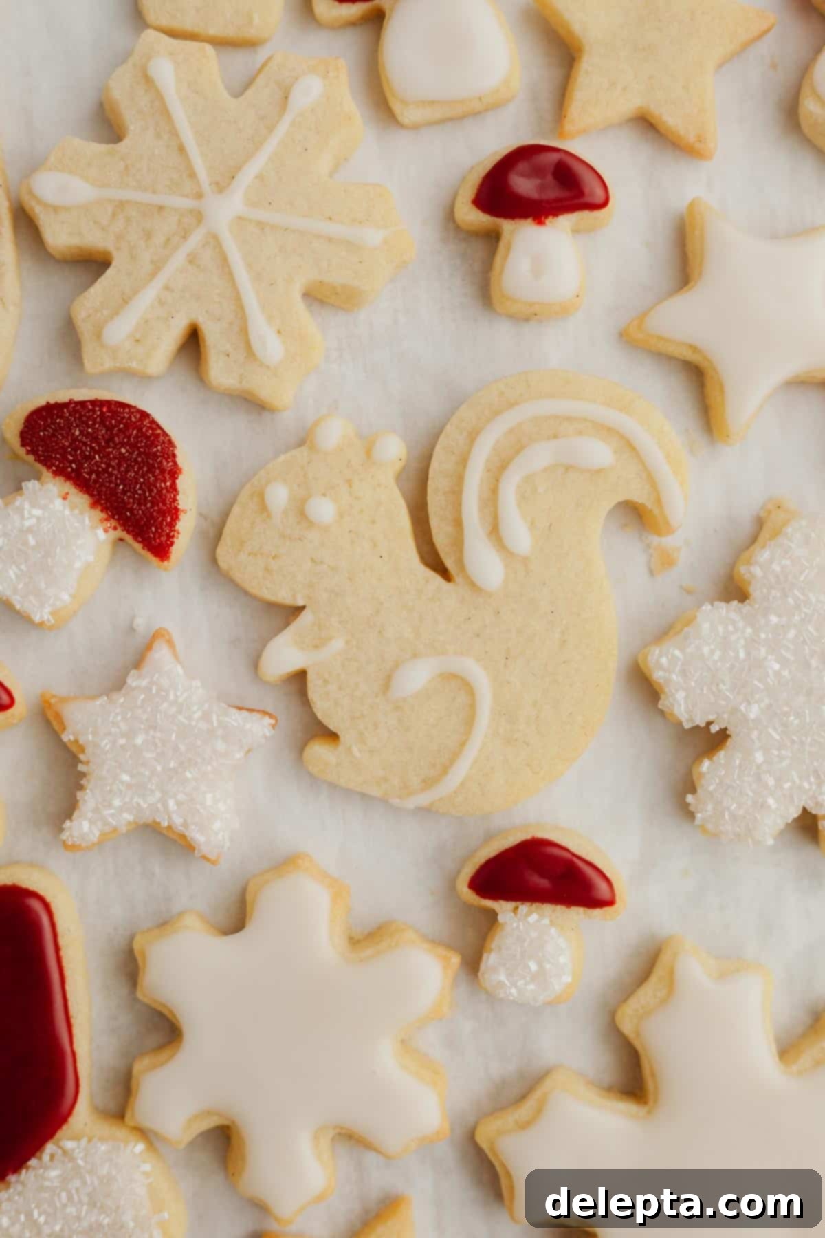 Flawless Cut-Out Sugar Cookies 8 A beautiful array of decorated no-spread Christmas sugar cookies, including trees, snowflakes, and mittens.