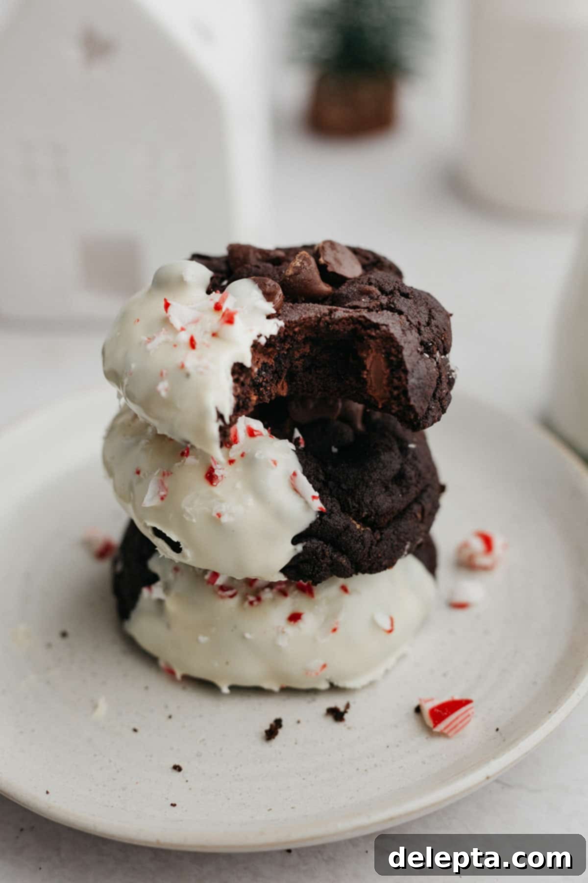 Festive Peppermint Bark Delights 7 A stack of three peppermint bark cookies on a small plate.
