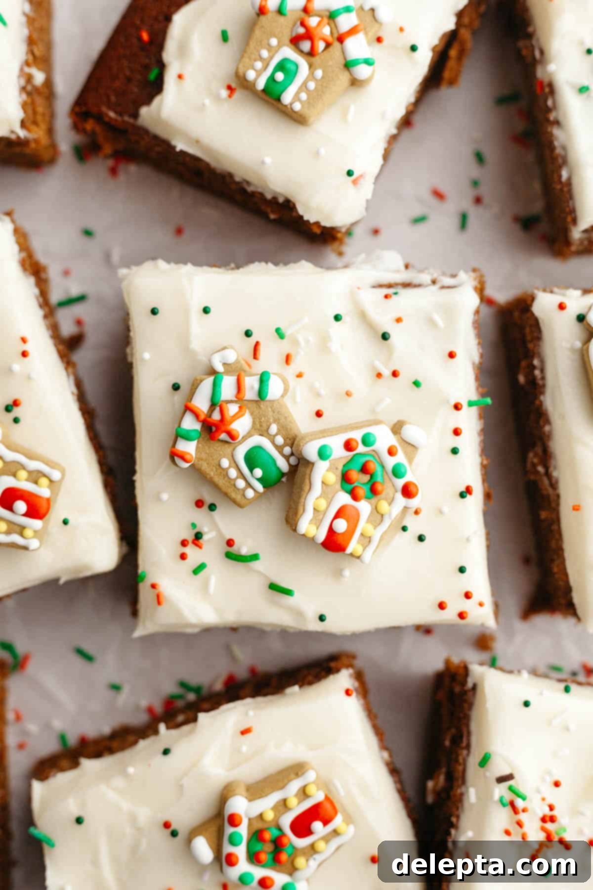 Cozy Gingerbread Cake with Cream Cheese Frosting 2 Square slices of frosted gingerbread cake with Christmas sprinkles.