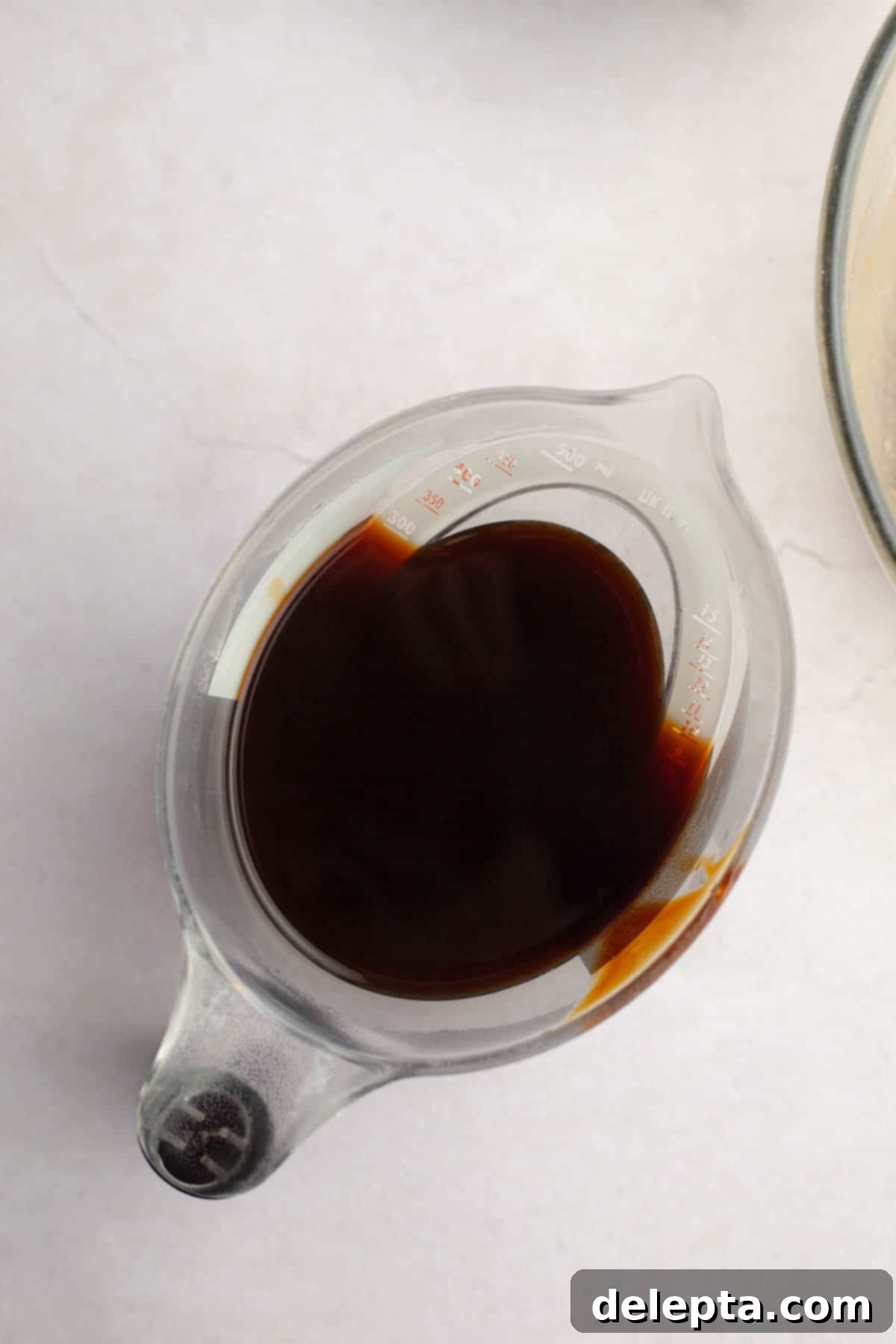 Cozy Gingerbread Cake with Cream Cheese Frosting 5 Molasses in a jug.