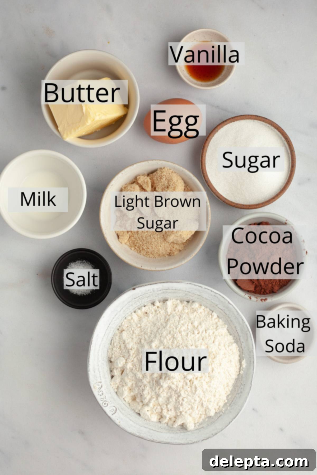 Velvet Cocoa Blossoms 3 All the ingredients needed to make cocoa blossom cookies, weighed out into small bowls, including flour, cocoa powder, butter, sugars, and eggs.