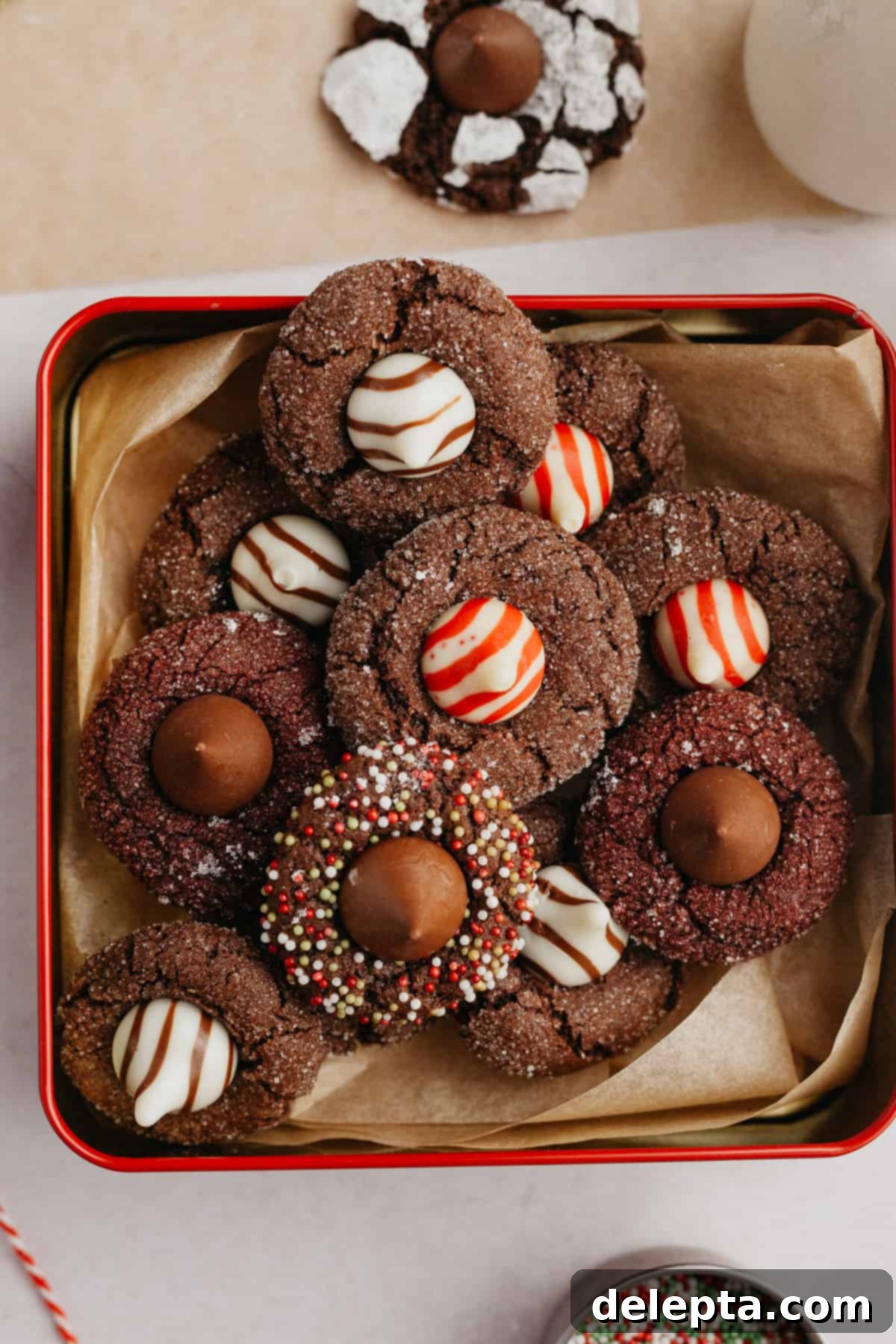 Velvet Cocoa Blossoms 9 An overhead shot of different varieties of cocoa blossom kiss cookies, artfully arranged on parchment paper.
