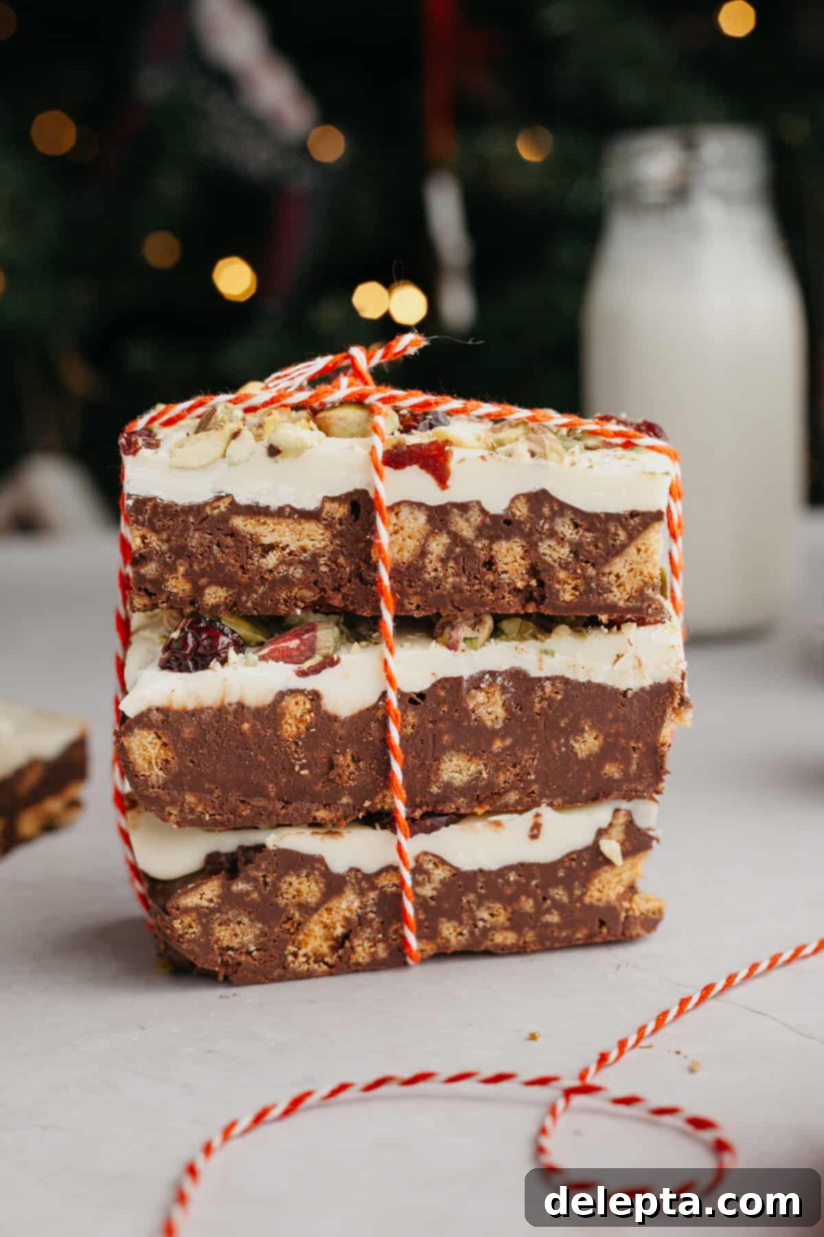 No-Bake Chocolate Biscuit Cake 2 a stack of 3 chocolate tiffin bars, tied up with red and white string.