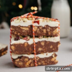 No-Bake Chocolate Biscuit Cake 8 a stack of 3 chocolate tiffin bars, tied up with red and white string.