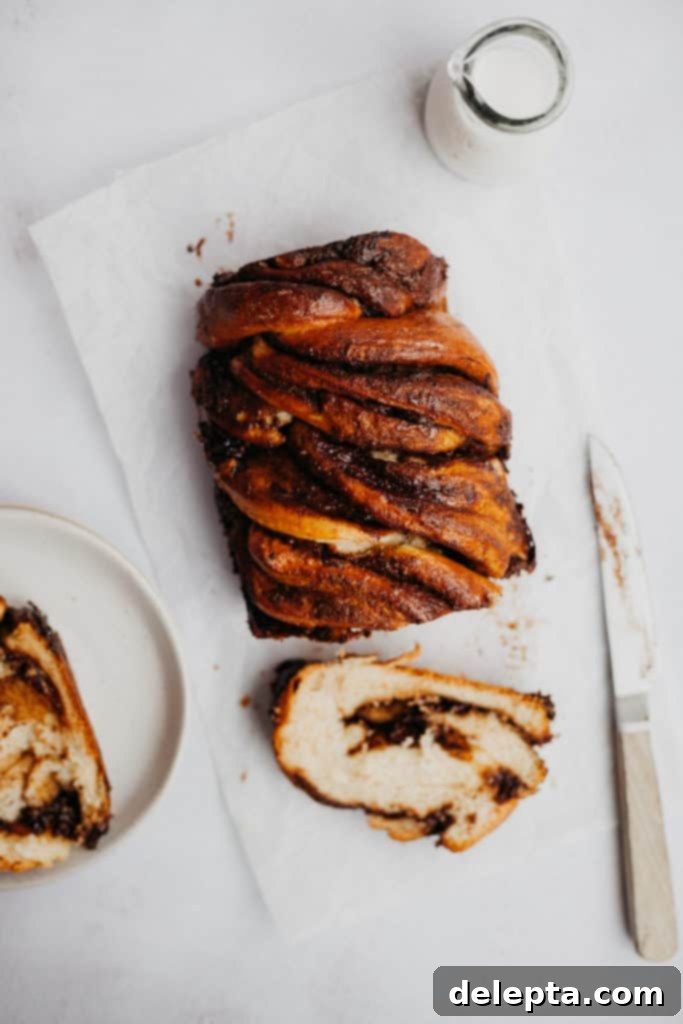Spiced Chocolate Gingerbread Babka 3 overhead view of a sliced babka with a small glass of milk