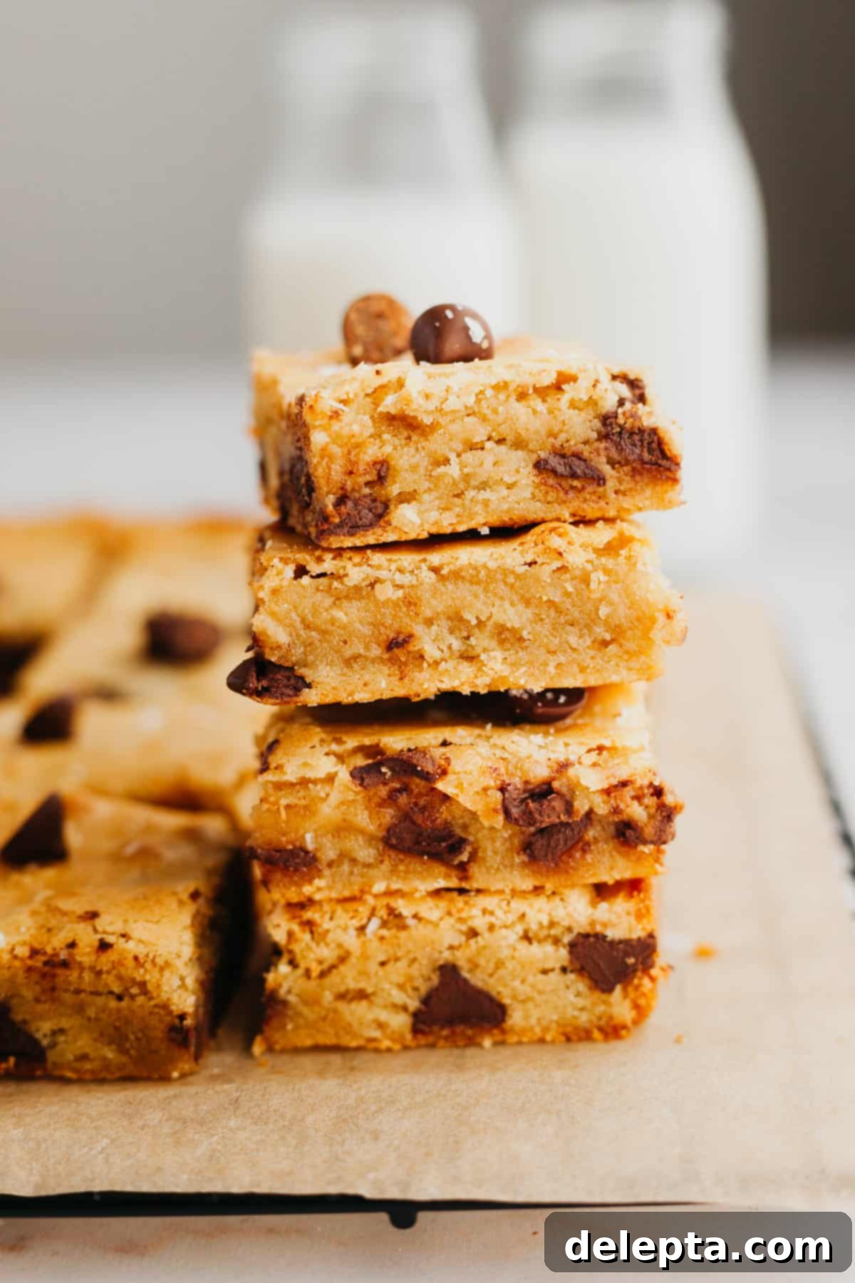 Caramelized Brown Butter Blondies Simple Perfection 2 A stack of four irresistibly fudgy chocolate chip brown butter blondies, showcasing their perfect texture and golden hue.