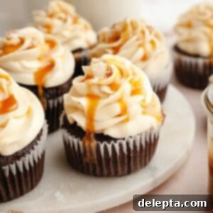 Decadent Chocolate Salted Caramel Cupcakes 12 Chocolate cupcakes with caramel buttercream on white marble.