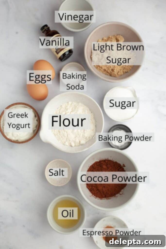 Decadent Chocolate Fudge Cupcakes 3 Ingredients needed to make chocolate cupcakes weighed out into small bowls.